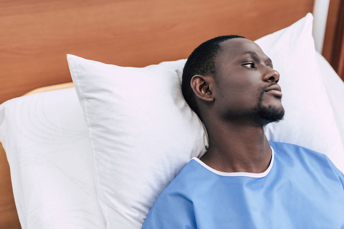 Male patient in hospital bed